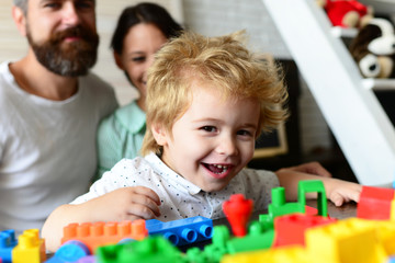 Young family spends time in playroom. Mom and dad