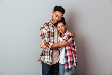 Portrait of a loving young african couple hugging