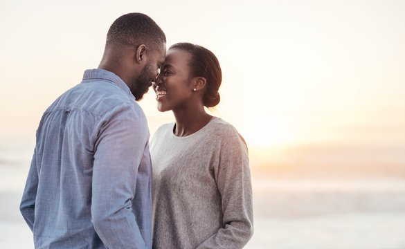 Young African couple enjoying a romantic moment at the beach