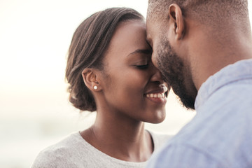 Romantic young African couple enjoying moment together at the beach