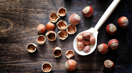 Nuts on a wooden table.Hazelnuts in the shells and shelled. A wo