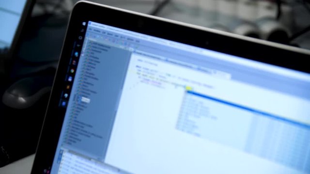 Writing programming code on monitor. Writing program code on computer. Website programming code. Developer working on websites codes in office. Programming code on computer screen.