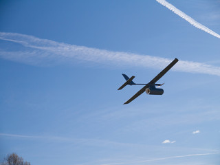 Fototapeta na wymiar drone airplane, low altitude passage, sunny sky with clouds