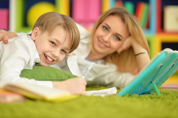 Fototapeta premium Mother with her son doing homework