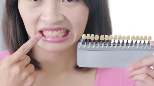 woman take tooth color palette