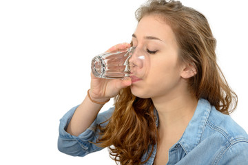 young woman drinking a glass of water, on white