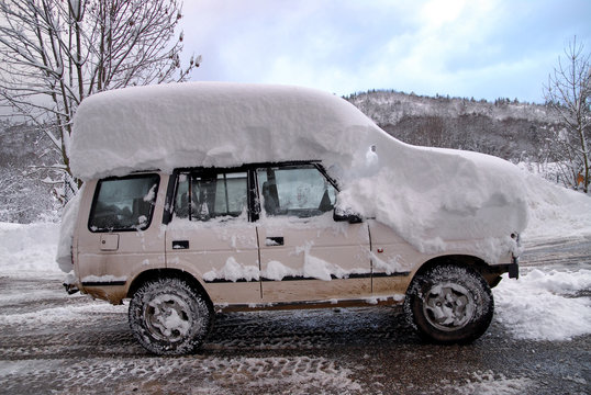 Roof Of The Car Covered With Snow