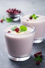 Clean eating cranberry oatmeal banana smoothie on concrete or stone background. Selective focus, copy space, close up. 