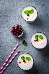 Frozen cranberry banana smoothie on concrete or stone background. Top view, copy space.