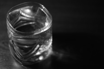 a glass of water on a black background black and white