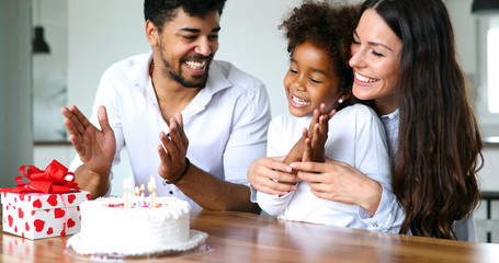 Happy family celebrating birthday of their child