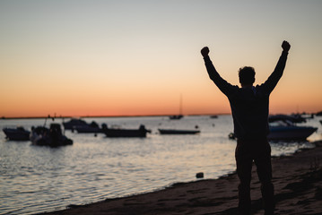 Fototapeta premium Man watching the sunrise in Portugal