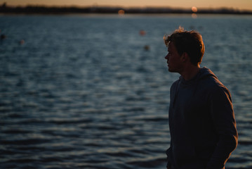 Man watching the sunrise and walking around on the beach in Portugal