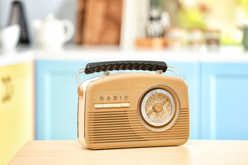 Stylish radio receiver on kitchen table