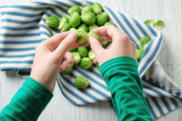 Woman with Brussels sprouts in kitchen
