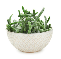 Bowl with frozen green beans on white background