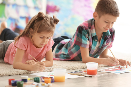 Little children painting on floor