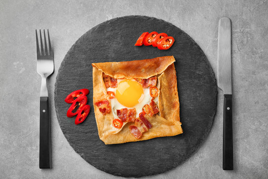 Tasty Thin Buckwheat Pancake With Egg On Slate Plate