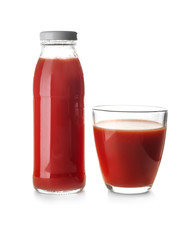Bottle and glass with juice on white background