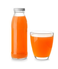 Bottle and glass with juice on white background