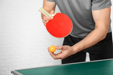 Man playing table tennis indoors