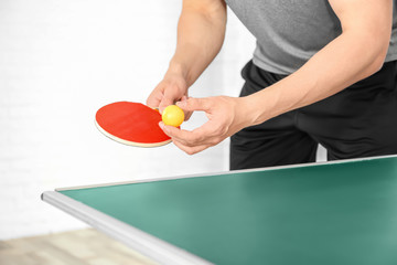 Man playing table tennis indoors