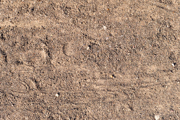 sandy path road with boot tracks. background, texture.