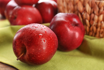 Delicious red apples on table