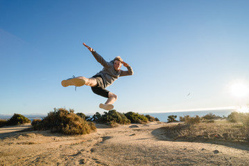 Man jumping on the cliff in Portugal