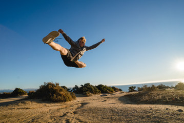 Man jumping on the cliff in Portugal