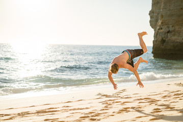 Man jumping on the beach in Portugal