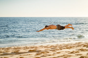 Man jumping on the beach in Portugal