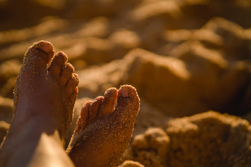 Feet in sand on the beach in Portugal