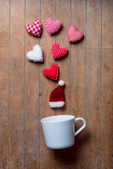 White cup on lying on side with Santa Claus hat