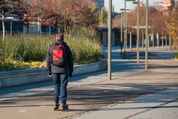 Man rollerblading in public city park