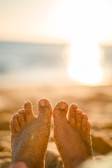 Feet in sand on the beach in Portugal