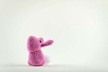 Pink crochet rabbit on plain white