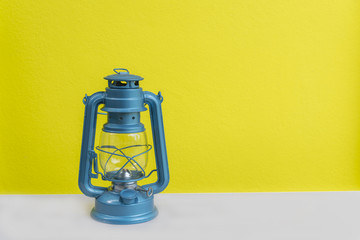 The blue lantern is laid on a gray background with a yellow background.