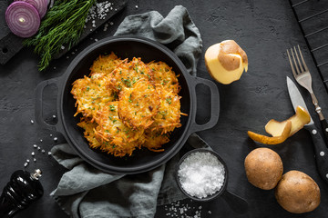 Potato pancakes on dark background, top view