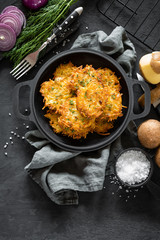 Potato pancakes on dark background, top view