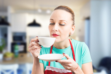 Housemaid or housekeeper taking a coffee break