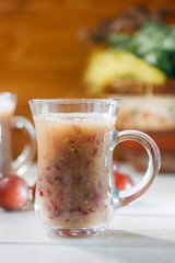 Grape smoothie over the white table.