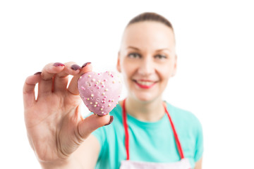 Red apron woman showing hearth shape gingerbread