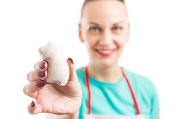 House wife holding and showing gingerbread