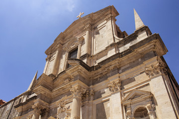 Bottom view of Saint Ignatius Church in Dubrovnik old town with clear blue sky background.