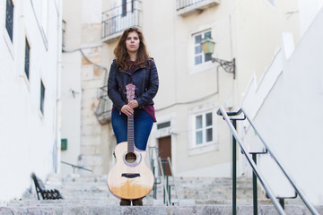 Pretty Woman Holding Guitar on Street Stairway