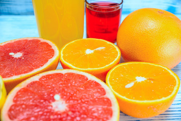 orange lemon grapefruit and juice on a light wooden background background 