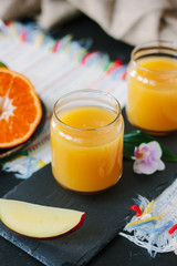 Glass filled by fresh mango and orange juice.