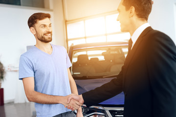 Two men shake hands, making a deal.