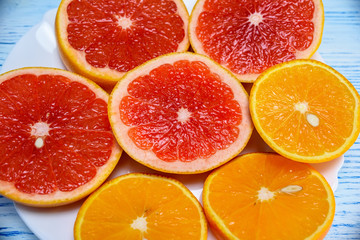 Naklejka na ściany i meble orange lemon grapefruit on a light wooden background background 